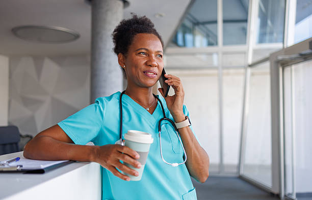 istock Smiling doctor making a phone call during coffee break 2235753206