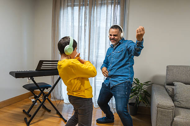 istock Father and son dancing and having fun at home 2235753871