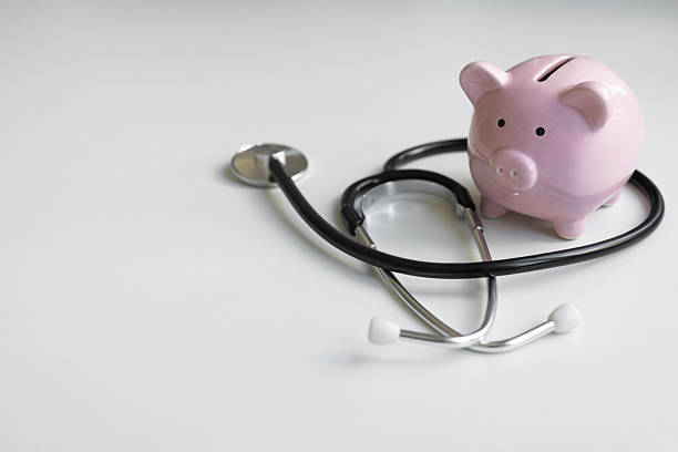 istock Piggy bank with stethoscope on white 2235754374