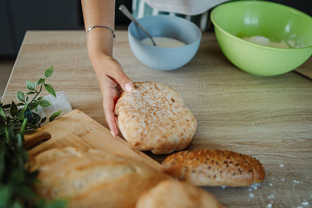 istock Young caucasian woman making bread dough in her kitchen 2235755454
