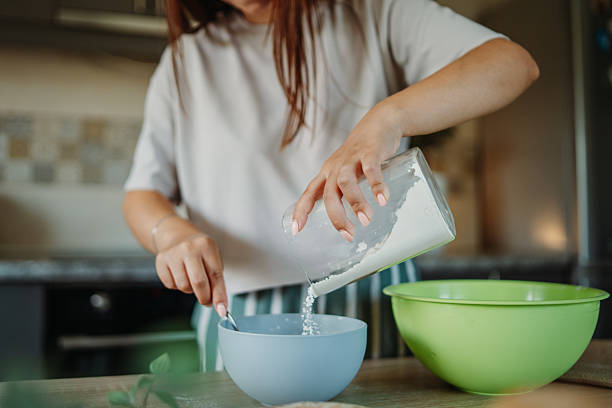 istock Young caucasian woman making bread dough in her kitchen 2235755474