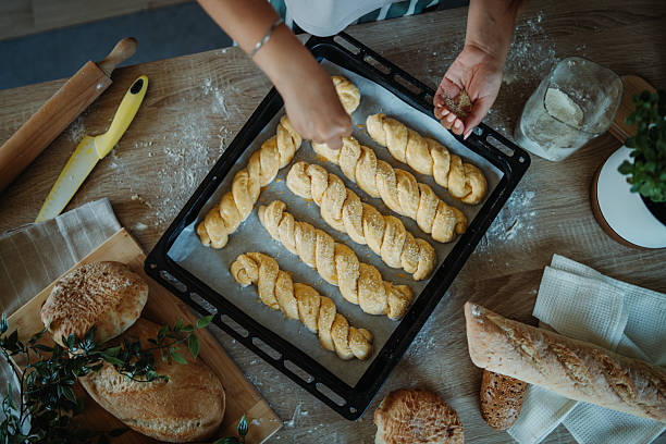 istock Young caucasian woman making bread dough in her kitchen 2235755543