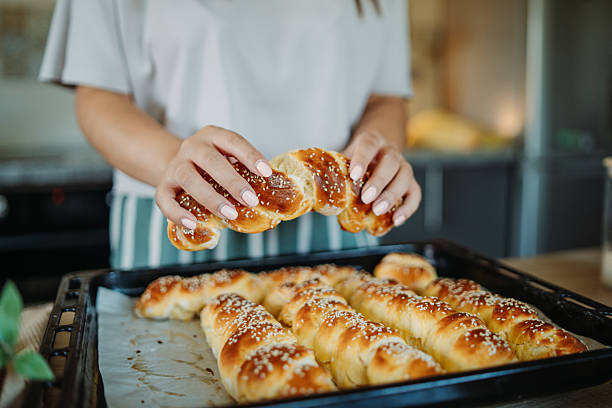 istock Young caucasian woman making bread dough in her kitchen 2235755599