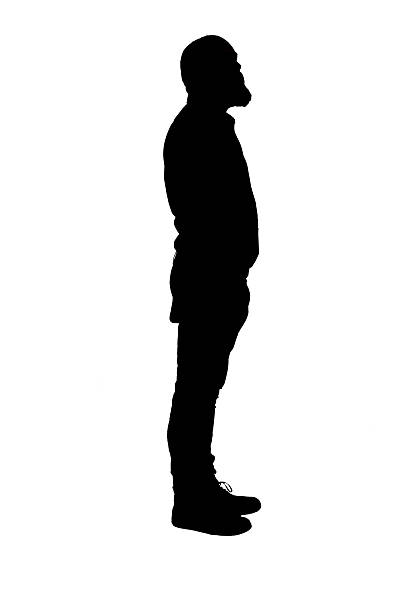 istock silhouette of a side view of a man standing,  looking up 2235758525