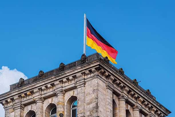 istock German National Flag Displayed Atop Historic Building in Berlin 2235759934