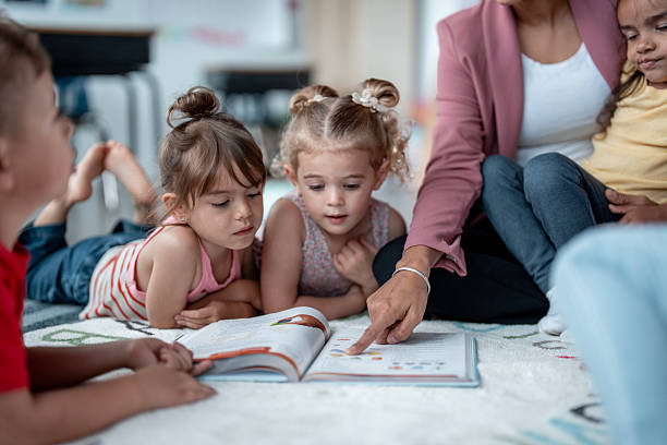 istock Young Children Learning Together with Teacher in Classroom Setting 2235760136