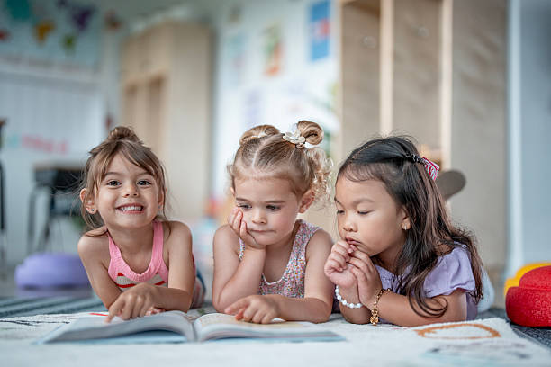 istock Three Young Girls Reading Together in a Classroom Setting 2235761009