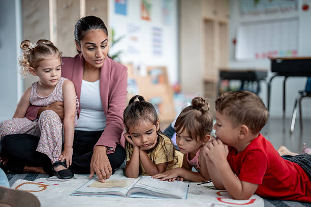istock Educator Reading Storybook to Diverse Group of Young Children in Classroom Setting 2235761334