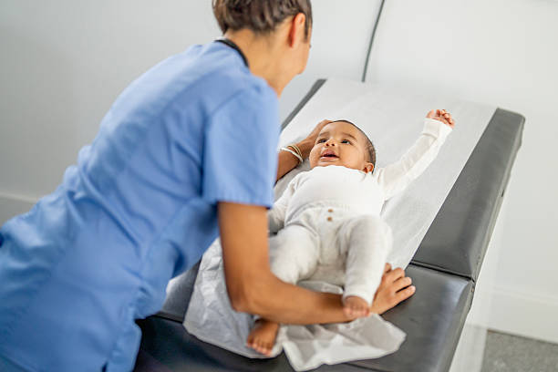 istock Healthcare Professional Interacting with Infant During Check-Up 2235762347