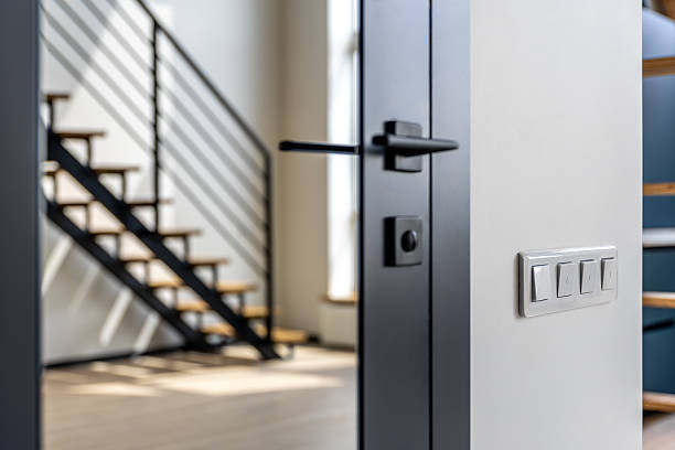 istock Light switches near metal door handle and stairs. Lighting control. 2235763207