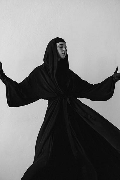 istock Graceful Woman in Flowing Black Robe in Minimal Setting 2235764753