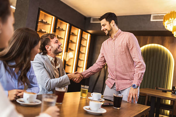 istock Handshake between two people in modern cafe, symbol of agreement, partnership and connection 2235768773