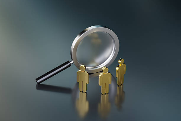 istock Magnifying Glass and Figures Representing Recruitment Or Analysis 2235768779
