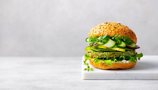 istock Healthy vegan burger with vegetables patty on a cutting board. Light grey background. Copy space. Close up. 2235770115