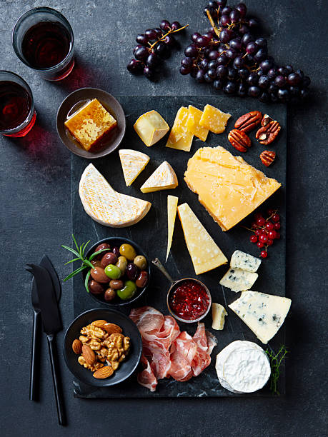 istock Cheese assortment on slate cutting board with glass red wine. Grey background. Top view. 2235770122