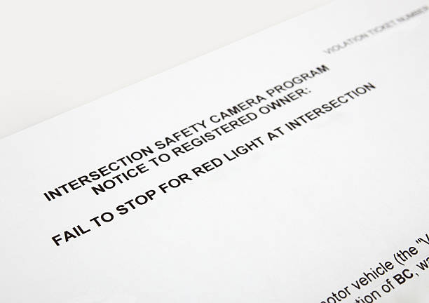 istock Traffic ticket for failing to stop on red light at intersection. 2235772236