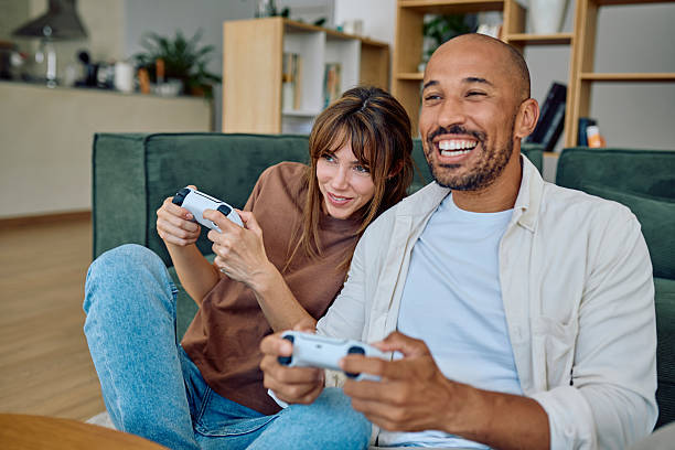istock Happy couple playing video games at home 2235775123