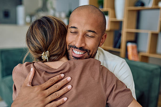 istock Happy man embracing woman at home 2235775429