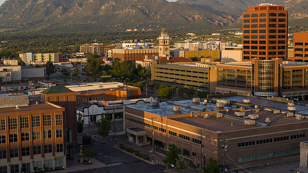 istock Mountain backdrop frames central business district in Colorado Springs, Colorado. Historic courthouse clock tower visible among modern office buildings. 2235775540