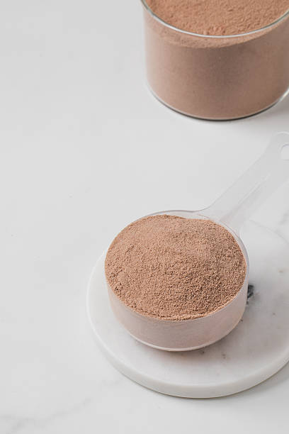 istock Protein chocolate powder scoop on marble surface. 2235775561