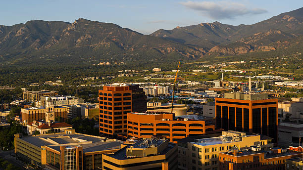 istock Front Range mountains frame Colorado Springs skyline. Historic courthouse tower visible among modern office buildings at sunrise. 2235775825