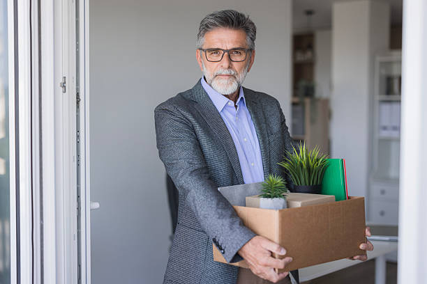 istock Sad fired mature businessman leaving office carrying box 2235775926