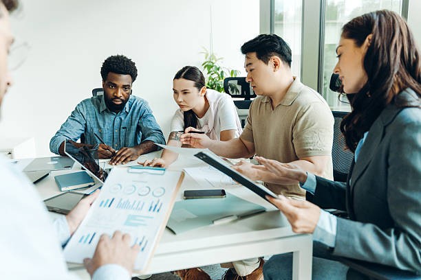 istock Business people working together in modern office analyzing financial charts and documents 2235777204