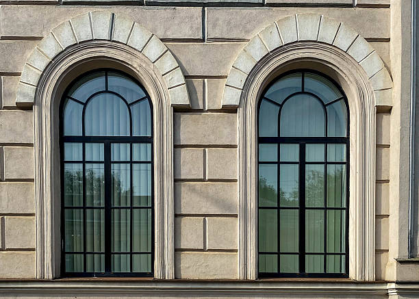 istock Ornate large arched windows. Great decorated historic building facade 2235778160