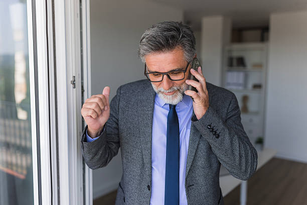 istock Businessman talking on phone in office, making gestures 2235778185