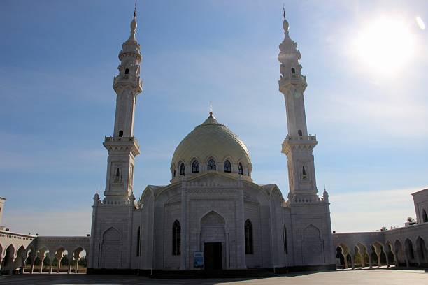 istock White Mosque with Twin Minarets Under a Blue Sky 2235780040