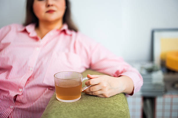 Woman Relaxing Indoors With a Tea Cup in Cozy Atmosphere