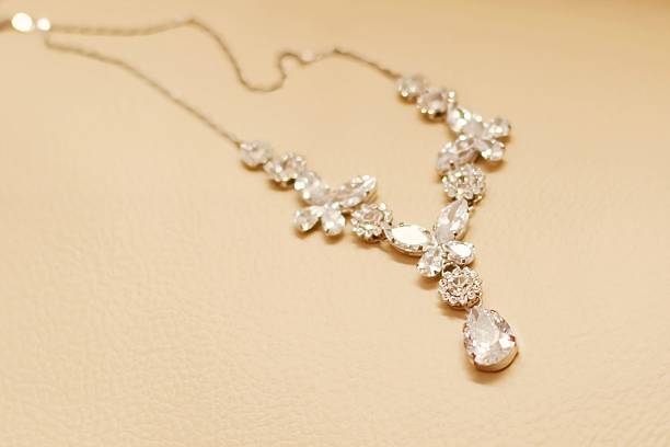 istock Elegant Crystal Necklace on a Light Beige Surface 2235781468