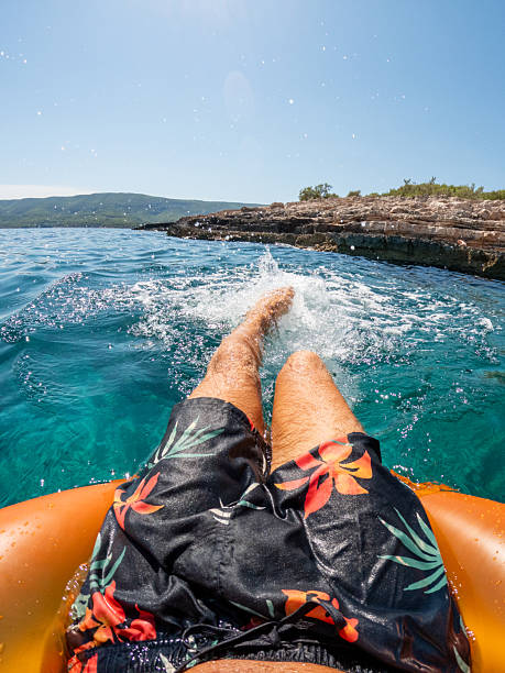 istock Man Relaxing on Float in Clear Blue Water 2235781628