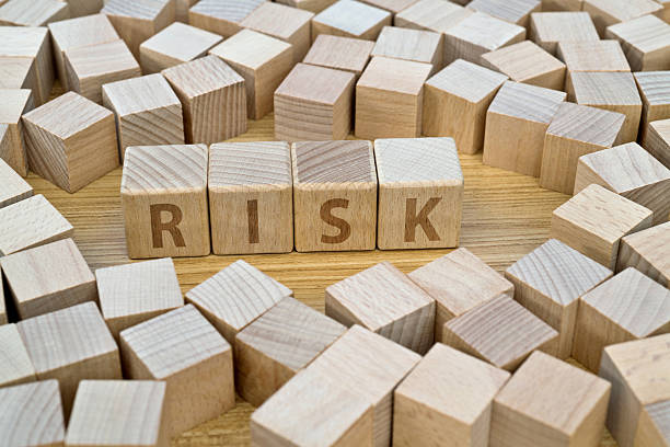 Wooden cubes with word risk on table.