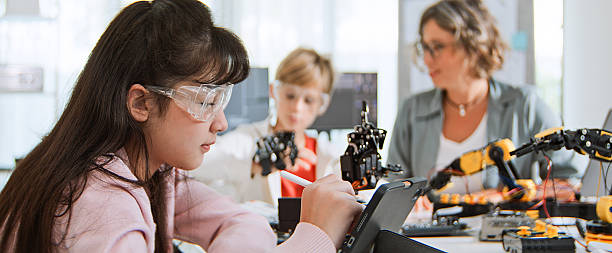 istock White family of mother, daughter, son homeschooling using computer and robotic arm controller. Young kids education at home with parent, technology knowledge learning, artificial intelligence concept 2235789140