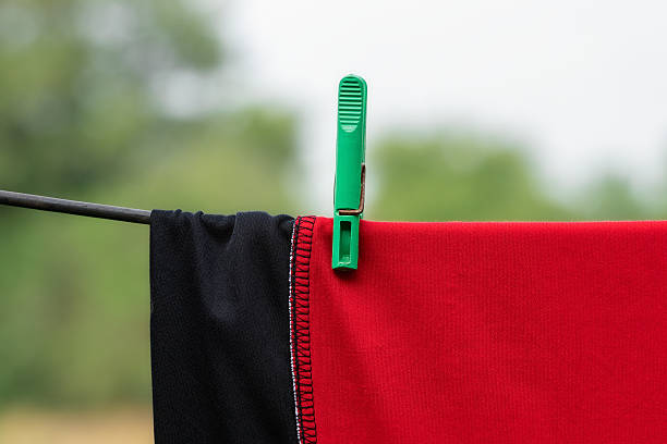 Minimalistic household object concept for daily life.Plastic green clothespin.