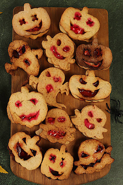 istock Scary ghost cookies,ghosts and pumpkins on old concrete background,cafe advertisement and menu,restaurant business card,Halloween food concept,idea for cooking holiday dishes for kids and adults. 2235791196