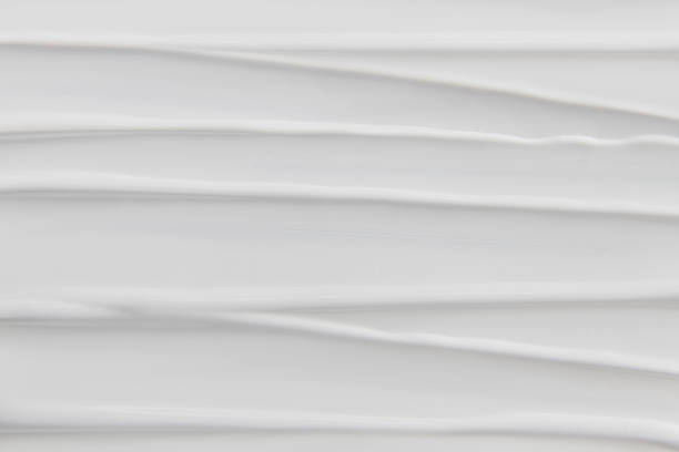 istock Horizontal smear of white cosmetic cream covering background 2235792131