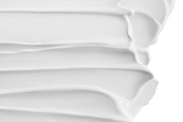 istock Thick layered texture of white cream spread across surface 2235792152