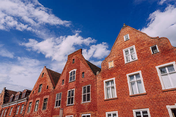 The iconic Hollandisches Viertel in Potsdam features stunning brick buildings with characteristic facades. A serene view of these structures with clear blue skies highlights the district's architectural beauty.