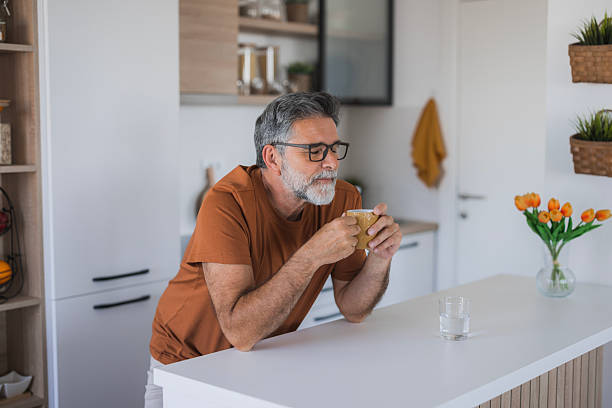 istock Mature man enjoying a cup of coffee in his modern kitchen 2235794166