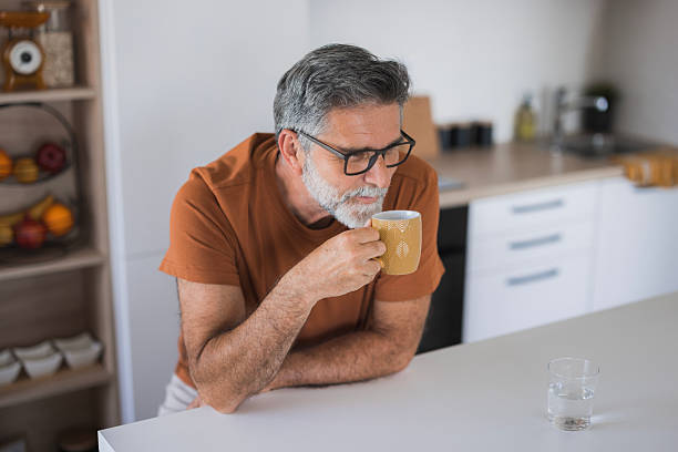 istock Mature man enjoying a cup of coffee in his modern kitchen 2235794229