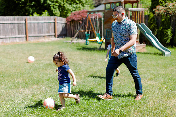 istock Latino Father and children Playing Together in backyard 2235794564