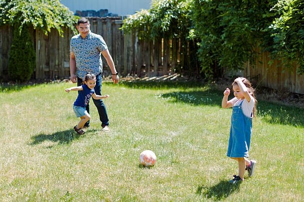 istock Latino Father and children Playing Together in backyard 2235794566