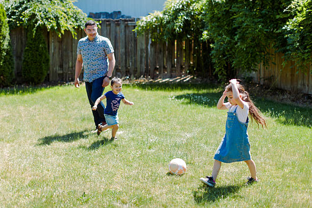 istock Latino Father and children Playing Together in backyard 2235794582
