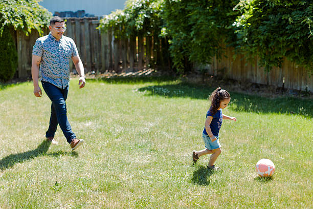 istock Latino Father and children Playing Together in backyard 2235794584