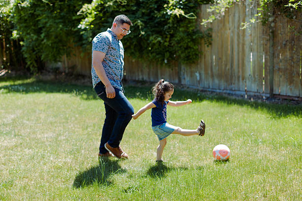 istock Latino Father and children Playing Together in backyard 2235794585