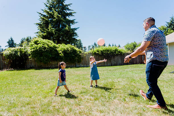istock Latino Father and children Playing Together in backyard 2235794736
