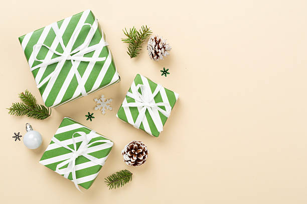 istock Striped Christmas gift boxes on color background, top view 2235795327