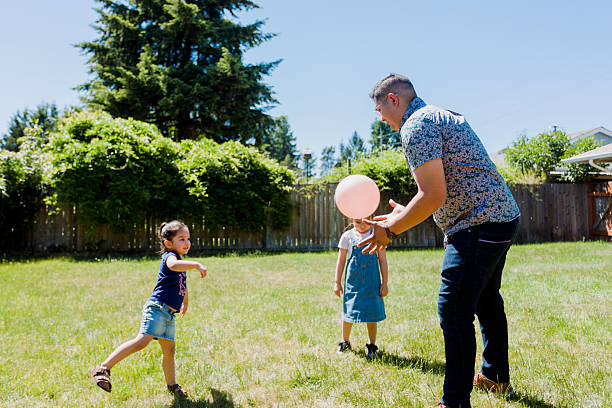 istock Latino Father and children Playing Together in backyard 2235798321